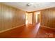 Bedroom featuring wood paneling and hardwood floors at 1470 Hilltop St, Albemarle, NC 28001