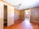 A bedroom featuring wood paneling, hardwood floors, and a ceiling fan at 1470 Hilltop St, Albemarle, NC 28001