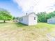 A white cottage-style home with green lawn and mature trees at 1470 Hilltop St, Albemarle, NC 28001