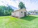 Detached garage sits on a well-maintained green lawn, offering convenient parking and storage at 1470 Hilltop St, Albemarle, NC 28001