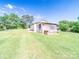 Detached garage with a green lawn, presenting opportunities for customization and expansion at 1470 Hilltop St, Albemarle, NC 28001