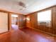 Living room with wood paneled walls, worn hardwood floors, and natural light at 1470 Hilltop St, Albemarle, NC 28001