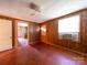 Living room with wood paneled walls, worn hardwood floors, and natural light at 1470 Hilltop St, Albemarle, NC 28001