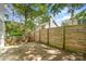 Backyard with a concrete patio, surrounded by a wooden fence and trees at 1533 Briar Creek Rd # A, Charlotte, NC 28205