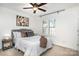 Bright bedroom with ceiling fan, neutral walls, and a comfortable bed with stylish pillows and art at 1533 Briar Creek Rd # A, Charlotte, NC 28205