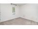 Neutral bedroom with white walls, carpet flooring, and a window with shutter blinds at 1533 Briar Creek Rd # A, Charlotte, NC 28205