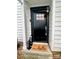 Inviting front door with a 'hello' mat and stylish lantern accents at 1533 Briar Creek Rd # A, Charlotte, NC 28205