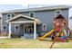 Expansive backyard featuring a playset, covered patio, and a hot tub area perfect for relaxing and entertaining at 1601 Calder Dr, Indian Trail, NC 28079