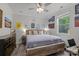 A spacious bedroom with hardwood floors, ceiling fan, a large bed and dresser at 1601 Calder Dr, Indian Trail, NC 28079