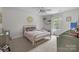 Charming bedroom featuring a gold metal bed frame, carpeted floors, and natural light from the window at 1601 Calder Dr, Indian Trail, NC 28079