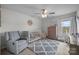 This cute bedroom has neutral decor, a ceiling fan, and a cozy rug on carpet at 1601 Calder Dr, Indian Trail, NC 28079