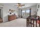 Cozy carpeted bedroom featuring a ceiling fan and a window with neighborhood views at 1601 Calder Dr, Indian Trail, NC 28079
