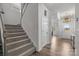 Welcoming entryway featuring a staircase, chandelier, and hardwood floors, offering a grand entrance to the home at 1601 Calder Dr, Indian Trail, NC 28079