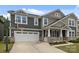 Charming two-story home with a two car garage, basketball hoop, landscaped yard, and covered front porch at 1601 Calder Dr, Indian Trail, NC 28079