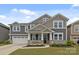 Charming two-story home with a welcoming front porch and well-manicured lawn in a lovely neighborhood at 1601 Calder Dr, Indian Trail, NC 28079