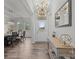 Bright foyer featuring hardwood floors, modern chandelier, and adjacent dining area at 1601 Calder Dr, Indian Trail, NC 28079