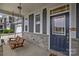 Inviting front porch featuring a wooden swing, stone accents, and a view of the well-manicured front yard at 1601 Calder Dr, Indian Trail, NC 28079