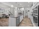 Modern, open-concept kitchen with white cabinets, a stainless steel dishwasher and island with granite countertop at 1601 Calder Dr, Indian Trail, NC 28079