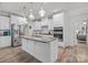 Spacious kitchen with white cabinets, a large island, stainless steel appliances, and modern pendant lights at 1601 Calder Dr, Indian Trail, NC 28079