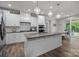Bright, modern kitchen with stainless steel appliances, granite countertops, and large center island at 1601 Calder Dr, Indian Trail, NC 28079