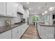 Well-equipped kitchen with white cabinetry, granite countertops, and stainless steel appliances, flowing to breakfast area at 1601 Calder Dr, Indian Trail, NC 28079