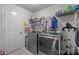 Functional laundry room equipped with a washer, dryer, and ample storage and hanging space at 1601 Calder Dr, Indian Trail, NC 28079