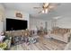 Spacious living room featuring hardwood floors, ceiling fan and a large entertainment center at 1601 Calder Dr, Indian Trail, NC 28079