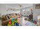 Bright living room features hardwood floors, a ceiling fan, and ample natural light from the large windows at 1601 Calder Dr, Indian Trail, NC 28079