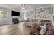 Comfortable living room featuring a fireplace, hardwood floors, a ceiling fan and lots of natural light at 1601 Calder Dr, Indian Trail, NC 28079