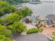 Aerial view of an estate home with lush landscaping, circular driveway, and lake access at 16108 Woolwine Rd, Charlotte, NC 28278