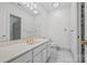 Bathroom featuring shower, toilet, and sink with large mirror and gold fixtures at 16108 Woolwine Rd, Charlotte, NC 28278