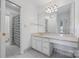 Bathroom featuring shower, toilet, and sink with large mirror and gold fixtures at 16108 Woolwine Rd, Charlotte, NC 28278