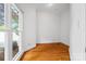 A light and bright bedroom features hardwood flooring and a large window at 16108 Woolwine Rd, Charlotte, NC 28278