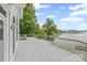 Large deck with railing overlooking the lake and mature trees at 16108 Woolwine Rd, Charlotte, NC 28278