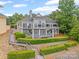 Beautiful waterfront home with multiple balconies, a stone seawall, and private dock access at 16108 Woolwine Rd, Charlotte, NC 28278
