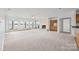 Spacious living room with fireplace, wet bar, and scenic waterfront views from multiple large windows at 16108 Woolwine Rd, Charlotte, NC 28278