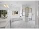 A luxurious main bathroom features dual sinks, a tub, and a glass-enclosed shower at 16108 Woolwine Rd, Charlotte, NC 28278
