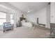 A spacious main bedroom is light and bright, featuring a sitting area and neutral decor at 16108 Woolwine Rd, Charlotte, NC 28278