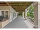 Expansive covered patio with ample space for entertaining and relaxing by the lake at 16108 Woolwine Rd, Charlotte, NC 28278