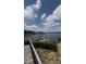 Scenic water view with docks and boat, plus a bridge in the distance, viewed from stone steps at 16108 Woolwine Rd, Charlotte, NC 28278