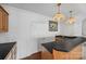 Wet bar with stone countertops and light wood cabinets and vintage pendant lighting at 16108 Woolwine Rd, Charlotte, NC 28278