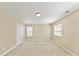 Spacious bedroom with neutral paint, carpet, large windows, and ample natural light at 17204 Caldwell Track Dr, Huntersville, NC 28078