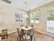 Bright dining area offering natural light, modern decor, and seamless access to the outdoors, perfect for casual gatherings at 17204 Caldwell Track Dr, Huntersville, NC 28078