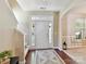 Foyer featuring hardwood floors, a decorative rug, and access to the staircase at 17204 Caldwell Track Dr, Huntersville, NC 28078