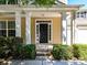 Inviting front entrance with classic columns, neatly trimmed bushes, and a black front door at 17204 Caldwell Track Dr, Huntersville, NC 28078