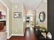 Hallway with hardwood floors, neutral walls, decorative art, and access to the living room at 17204 Caldwell Track Dr, Huntersville, NC 28078