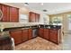 Spacious kitchen featuring dark cabinetry, granite countertops, stainless appliances and a seamless flow to the adjacent dining area at 17204 Caldwell Track Dr, Huntersville, NC 28078