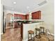 Open kitchen featuring dark wood cabinets, stainless appliances, a breakfast bar and direct access to the dining area at 17204 Caldwell Track Dr, Huntersville, NC 28078