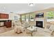 Open-concept living room and kitchen featuring a fireplace and comfortable seating at 17204 Caldwell Track Dr, Huntersville, NC 28078