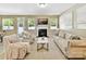 Comfortable living room with a fireplace, neutral decor, and ample natural light at 17204 Caldwell Track Dr, Huntersville, NC 28078